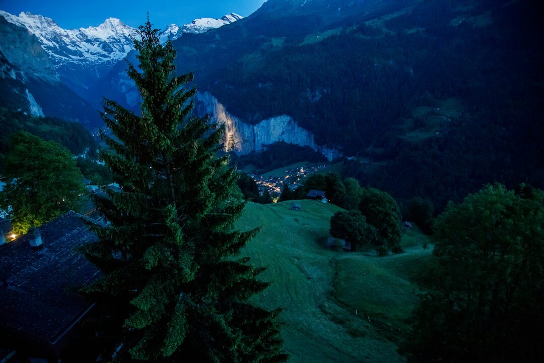 Swiss alpine chalet exterior glowing at dusk